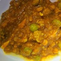 Keema Curry · Ground lamb cooked with green peas, tomatoes and onions. Served with basmati rice. 
