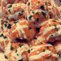 Buffalo Garlic KNOTS · 3 piece garlic knots tossed in our delicious buffalo sauce topped with ranch dressing Tomato...