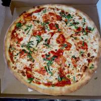 Margherita Pizza · The traditional Neopolitan pizza with homemade fresh mozzarella, fresh tomato basil sauce an...