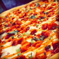 Chipotle Chicken Pizza · Fusion style chipotle chicken and bacon with fresh mozzarella garnished with scallions.