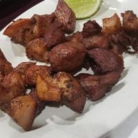 Carne Frita de Cerdo · Fried pork chop with a side. 