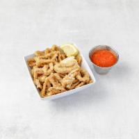 Calamari Fritti · Tender calamari floured then light fried and served with warm marinara sauce and a wedge of ...