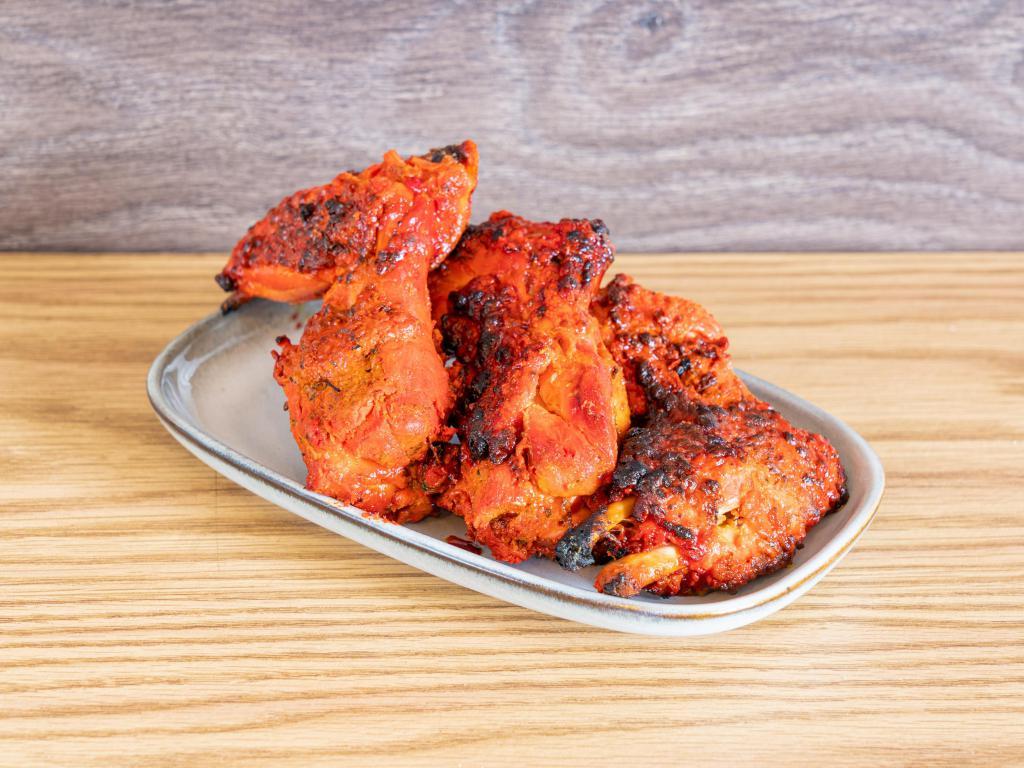 Tandoori Wings · Spicy chicken wings cooked in a tandoor oven. Complete your meal for an additional charge. 

