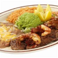 Carne Asada and Camarones at Mojo de Ajo · Tasty top sirloin steak served with succulent sauteed shrimp and guacamole. Served with refr...