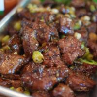 Black Pepper Beef Mignon · Chunks of tender beef wok-stirred with onions in a rich roasted black pepper sauce.