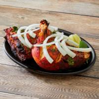 44. Half Tandoori Chicken · Chicken marinated in yogurt with various blends of herbs and spices, then barbecued in the c...