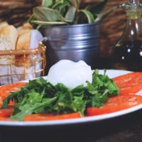 Fresh Burrata Salad · Served with tomatoes, arugula and balsamic vinegar.
