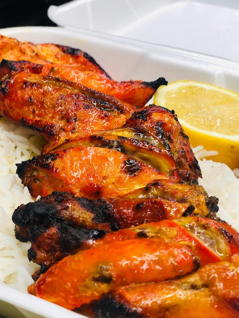 Chicken Jujeh Kabob · Cornish game hen marinated in lemon juice, saffron, onion, skewered and broiled over open flames. Served with basmati rice and grilled tomato and veggies.