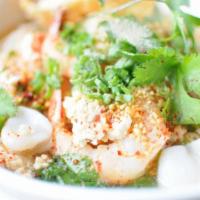 46. Tom Yum Noodle Soup · Rice noodles with prawns, squid, ground pork, lime juice, bean sprouts in broth topped with ...