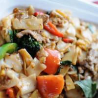 Pad Kee Mao · Stir-fried wide rice noodles with egg, basil, onions, carrots, tomatoes, bamboo shoots, and ...