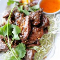 Tasty Beef · Stir-fried marinated beef in Thai herbs and spices on a bed of cabbage, served with plum sau...