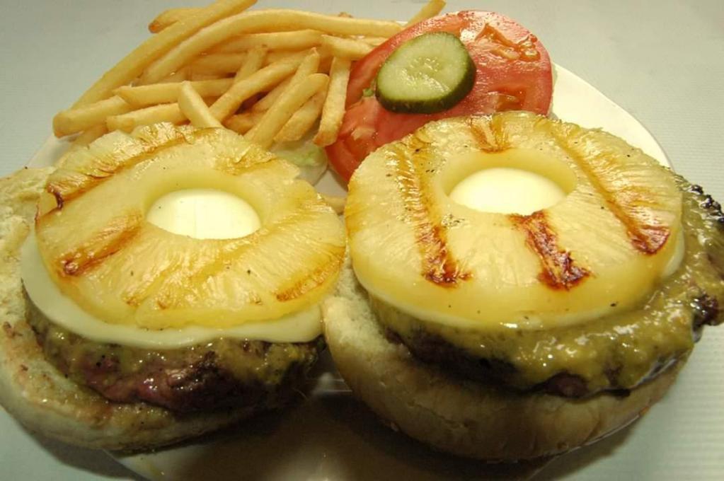 Hawaiian Double Cheeseburger · Angus beef patties with American cheese, lettuce, tomato and pickle topped with Grilled pineapple and homemade ginger dressing. Served with your choice of side.