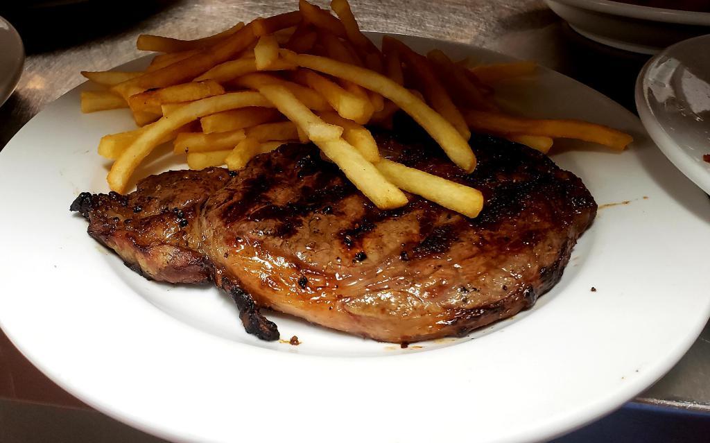 Ribeye Steak · Grilled steak .Served with salad and your choice of rice, french fries or vegetables.
