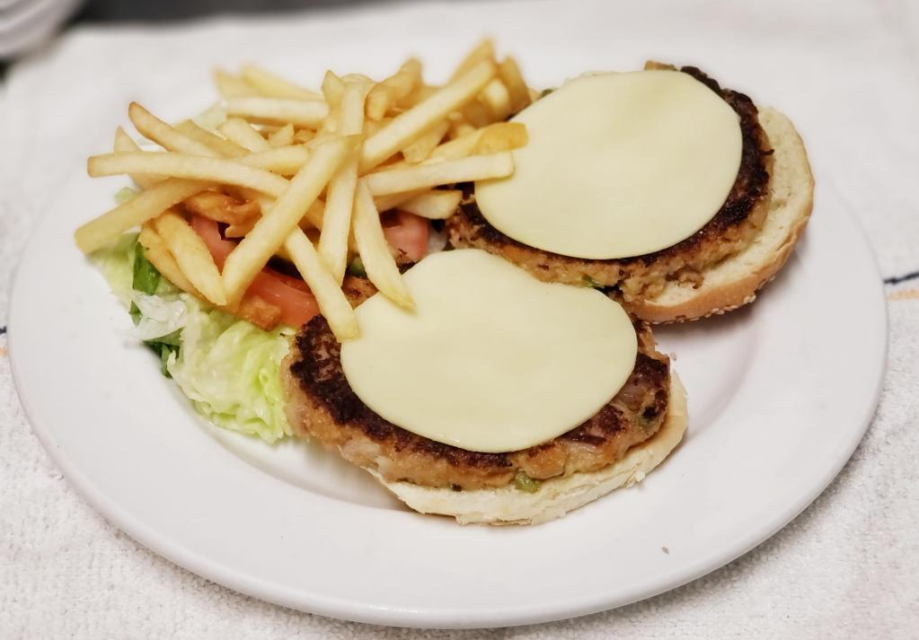 Charlie's Double Crab Cheese Burger · Homemade crab meat burger with American cheese, lettuce, tomato and pickles. Served with your choice of side.