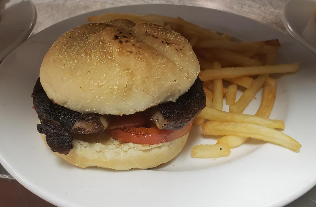 Portobello Mushroom and Grilled Tomato Sandwich · Grilled portobello mushroom with grilled tomatoes on a grilled bun. Served with your choice of side.