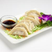 Steamed Dumplings · Dumplings filled with ground chicken, cabbage and scallion served with sweet soy sauce. (6pc...