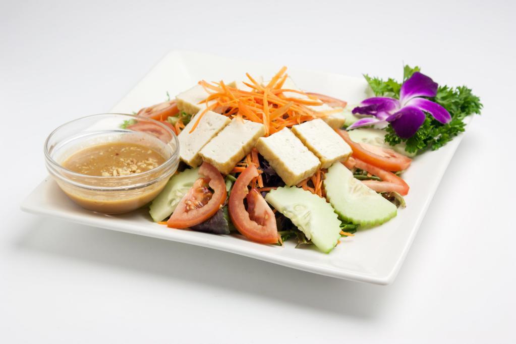 House Salad · Spring mix salad, tomato, cucumber, carrot and tofu served with peanut dressing.