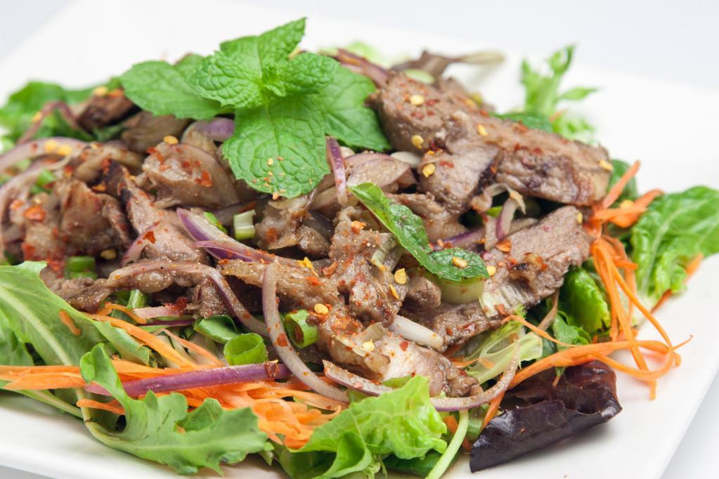 Beef Salad (Yum Nua) · Grilled sliced steak with spring mix salad, scallion, red onion, lime juice, chili, carrot, rice powder and mint.