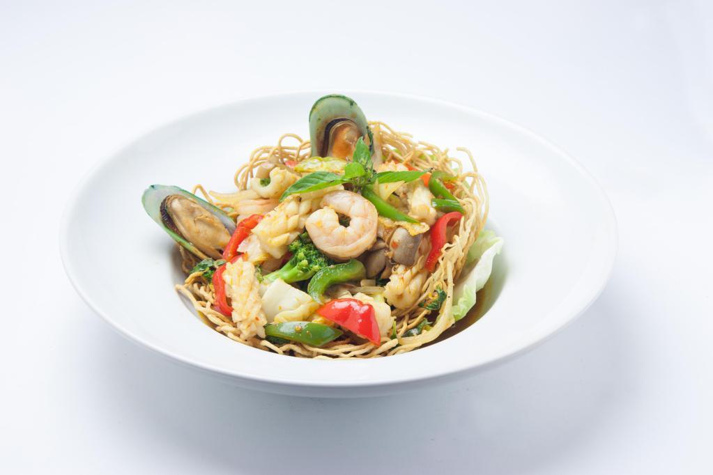 Bangkok Seafood · Stir fried shrimp, calamari, fish, green mussel with red & green bell pepper, mushroom, basil leaves, lime leaves, lemon grass, chili sauce served in a golden basket and steamed rice.