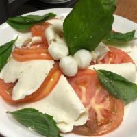Caprese · Fresh mozzarella cheese, tomatoes, basil and drizzled with olive oil.