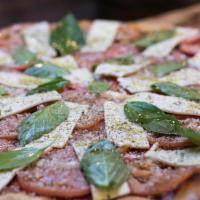 Caprese Pizza · Sliced tomato, fresh mozzarella, extra virgin olive oil, topped with fresh basil and romano ...