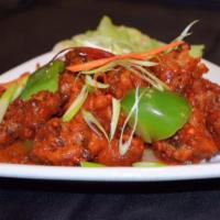 Chili Chicken · Chicken Bites, battered with flour, sautéed with bell peppers, spring onions, chilies and bl...