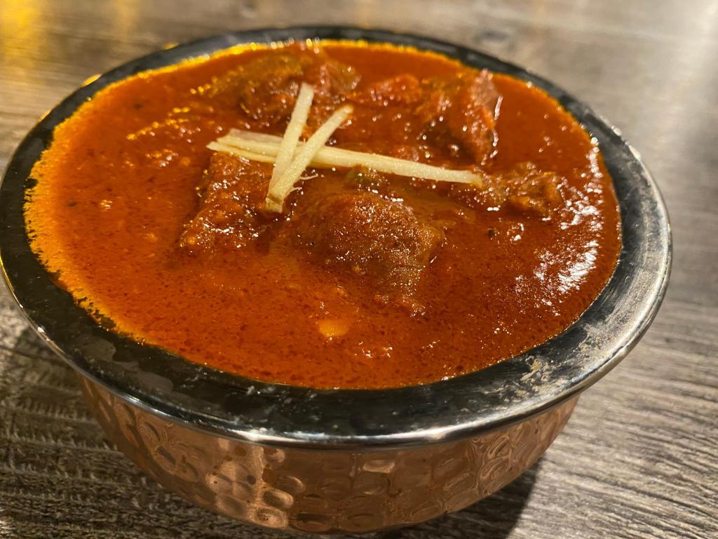Lamb/Goat Rogan Josh · Signature recipes of Kashmiri cuisine. Rogan josh was brought to Kashmir by the Mughals, whose cuisine was in turn influenced by Persian cuisine. Cooked in Stewed Dried Ginger, Fennel and Onions.

Served with Complimentary White Basmati Rice.