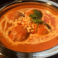 Saufyani Kofta Curry · Stuffed cottage cheese dumplings simmered in creamy tomato sauce cooked with aniseed and ble...