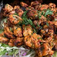 Chicken Tikka Kebab · Chicken breast strips marinated with yogurt and spices. Cooked in the clay oven.