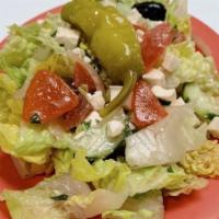 Greek Salad · Mix of romaine lettuce, cucumber, tomatoes, onion, parsley, feta cheese and olives with hous...