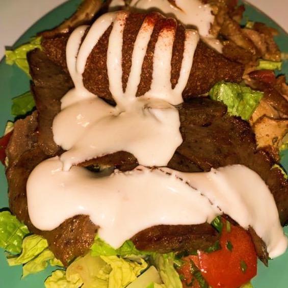 Combo Plate · Combination of gyros, chicken shawarma and kebbeh, served on a bed of lettuce, tomatoes, onions and parsley. Topped with tahini sauce.