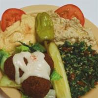 Veggie Combo Plate · Hummus, babbaganough, tabbuli salad and falafel served with tahini sauce and pita bread.