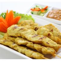 Satays Chicken · Grilled chicken skewers served with peanut sauce and cucumber salad.