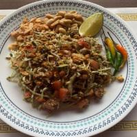 11. Tea Leaf Salad · Burmese tea leaves, cabbage, tomatoes, fried garlic, fried yellow beans, sunflower seeds, pe...