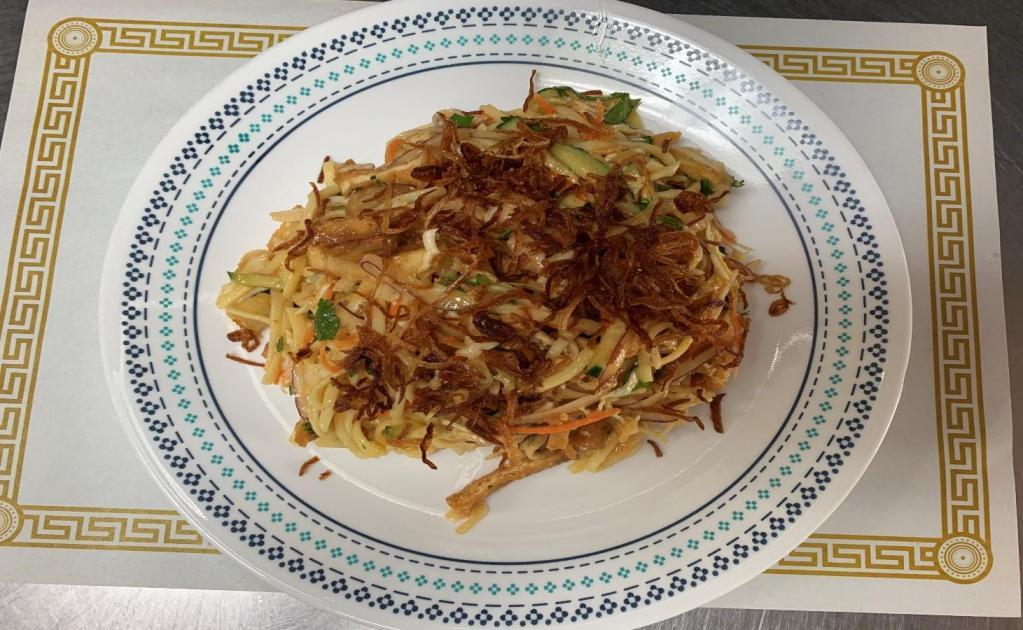17. Noodle Salad · Cabbage, egg noodle, cucumber, cilantro, fried potato, fried tofu, red onion and fried onion on top.