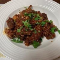 45. Fiery Spicy Fish · Deep fried catfish cooked with garlic and onion paste, fried chili flakes, cilantro and hous...