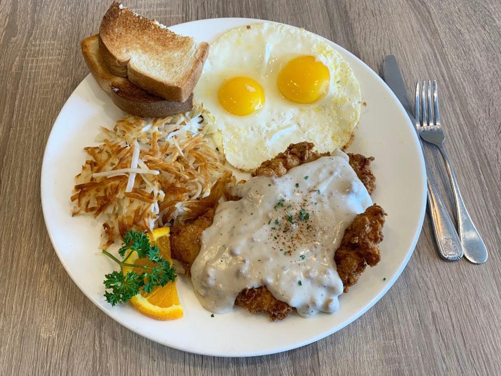 Farmer's Fried Steak · Country-style fried steak smothered in sausage gravy, plus 2 eggs any style, breakfast potatoes and toast. Includes 2 farm-fresh eggs any style, breakfast potatoes or hashbrowns and choice of toast: white or whole wheat.