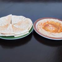 Hummus · Creamy blend of chickpeas, lemon, garlic, and olive oil. Served with pita bread.