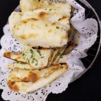 Naan · Traditional soft white bread.