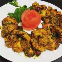 Reshmi Kebab Tandoor · Boneless chicken, marinated with yogurt, almond paste, ginger and garlic. Served as a sizzle...