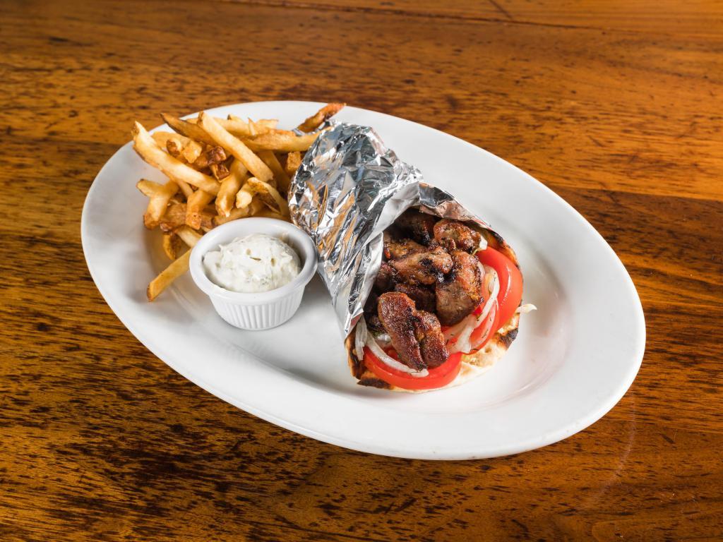 Pork Souvlaki Sandwich · Chunks of seasoned grilled Pork chunks wrapped in a pita with lettuce, tomatoes, and onions. Served with a side of tzatziki on the side