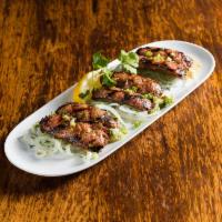 App Loukaniko · Grilled homemade Greek sausage (pork & lamb with leeks ) and spices.