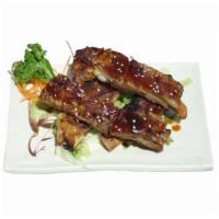 10. Pork Ribs · Four pork ribs cooked with teriyaki sauce.