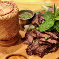 Crying Tiger · Grilled marinated flank steak served with spicy clipping sauce and sticky rice. Spicy.