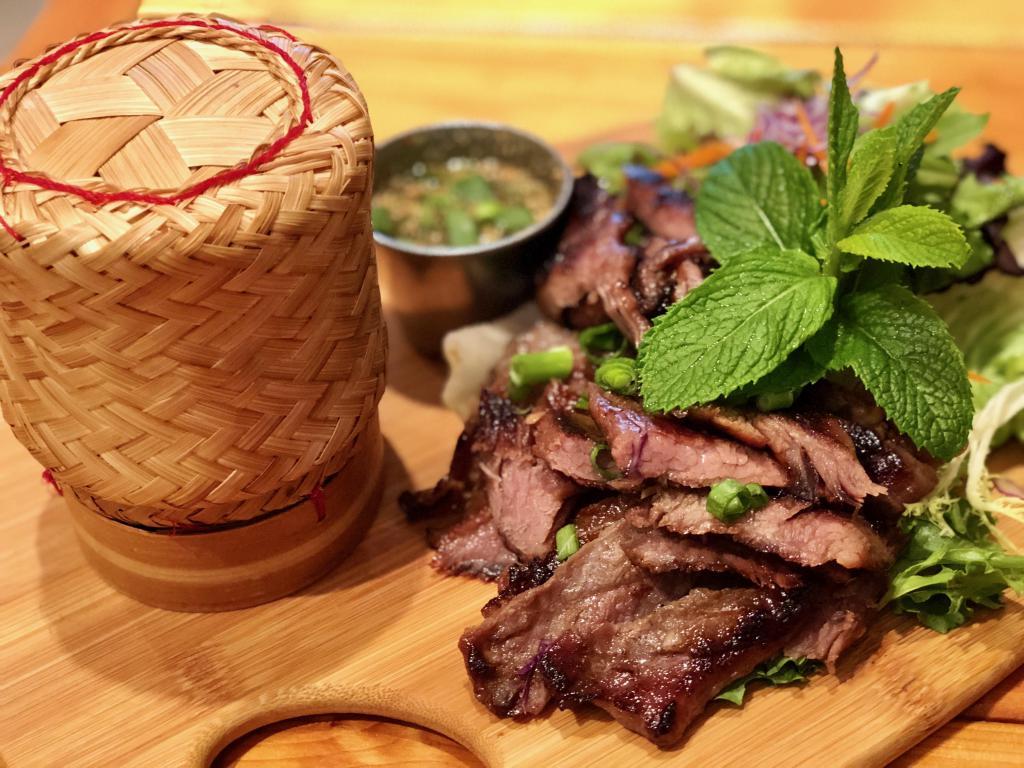Crying Tiger · Grilled marinated flank steak served with spicy clipping sauce and sticky rice. Spicy.