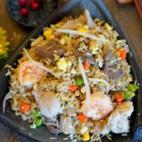 House Fried Rice · Steamed rice stir fried with meat chicken, pork, beef, shrimp and vegetables onion, peas and...