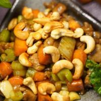 Cashew Chicken · Sliced chiceken stir fried with water chestnut, carrots, peas and onion in brown sauce on to...