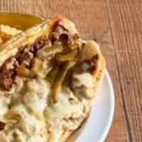 Philly Cheese Steak Sandwich · Choice of tender steak or chicken on a fresh-baked hoagie bun with grilled onions, green pep...
