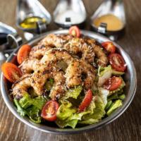 Cajun Shrimp Salad · Grilled Cajun seasoned shrimps with crisp hearts of romaine and baby arugula mixed with red ...