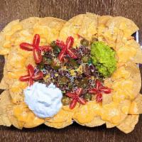 Bulgogi Nacho · Tortilla chips, Korean-style marinated beef rib-eye, assorted vegetables, jalapeño, corn, gr...